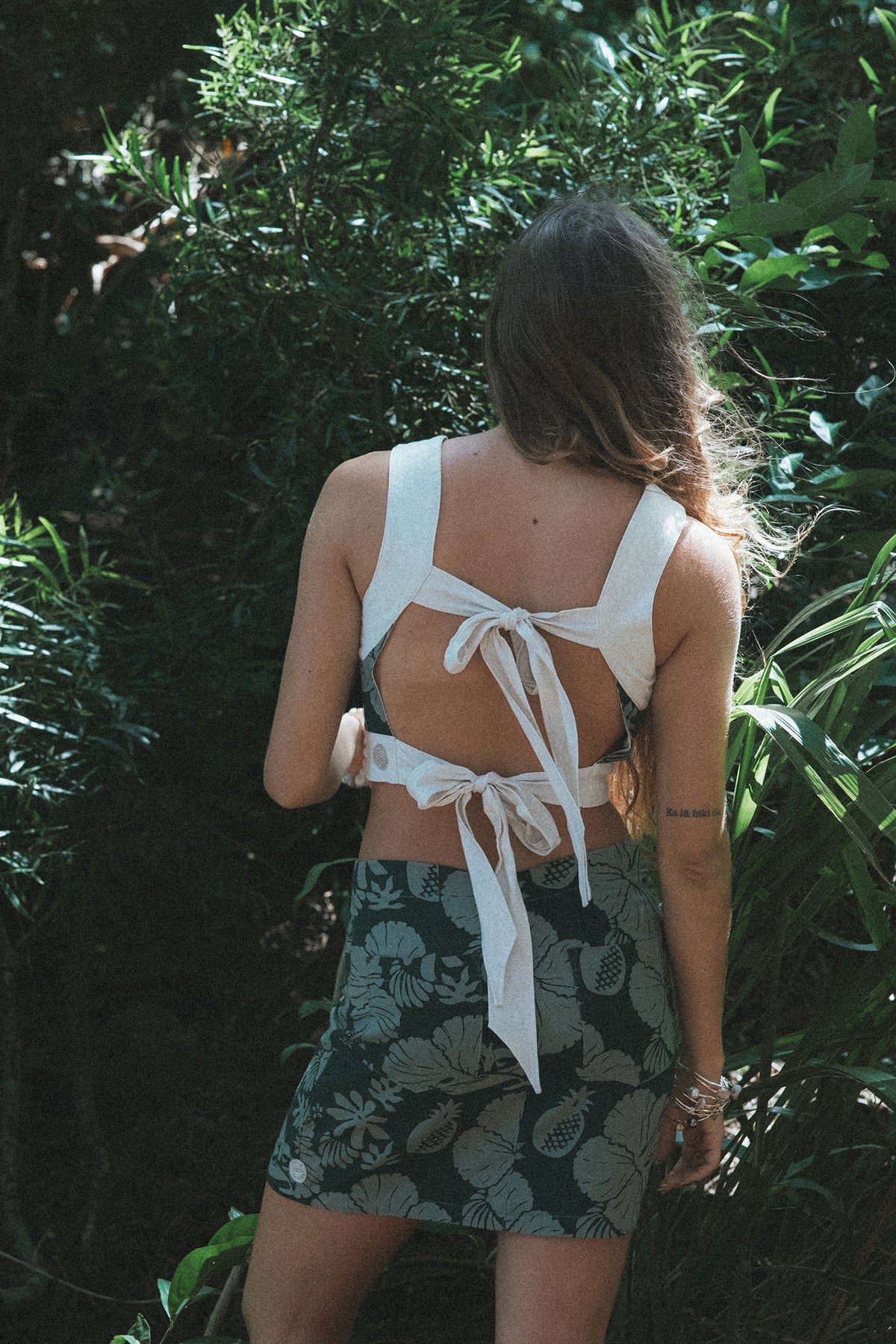 Wings Hawaii Retro Pocket Mini Skirt in Hana Forest. Dark and light green aloha print. Hand-drawn artwork designed in Maui, sewn in Bali. Small batch, sustainable, high quality women's apparel made with aloha. 
