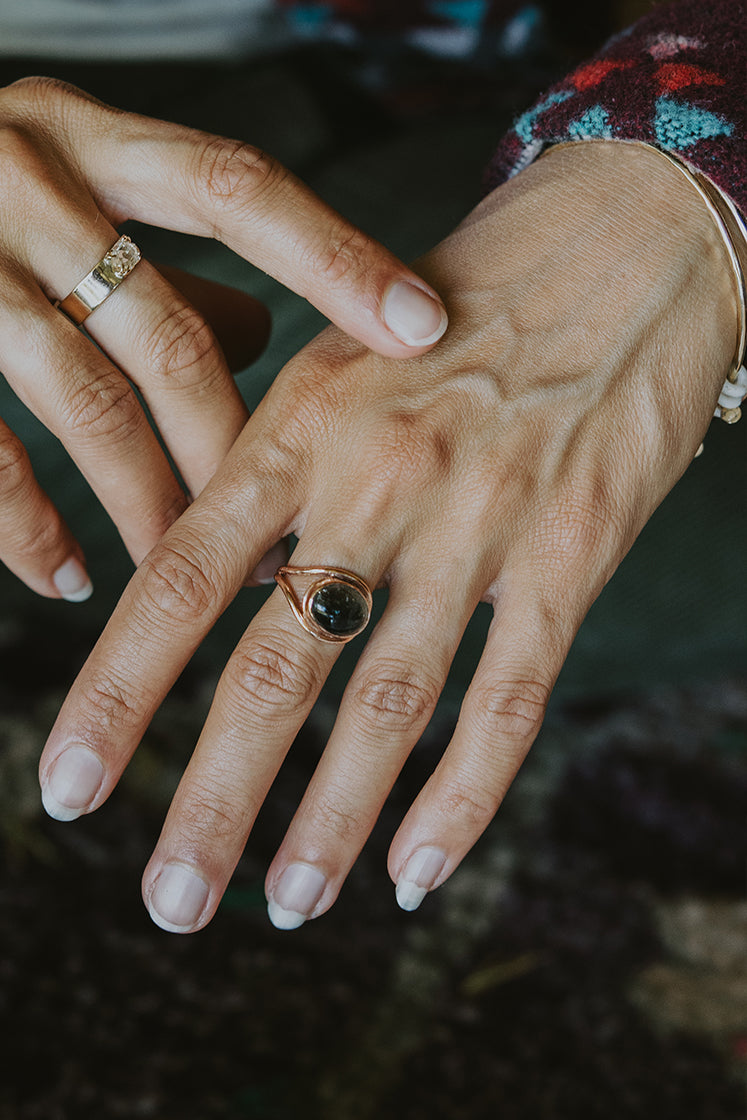 A Tourmaline set in 14K Yellow Gold int he shape of an evil eye