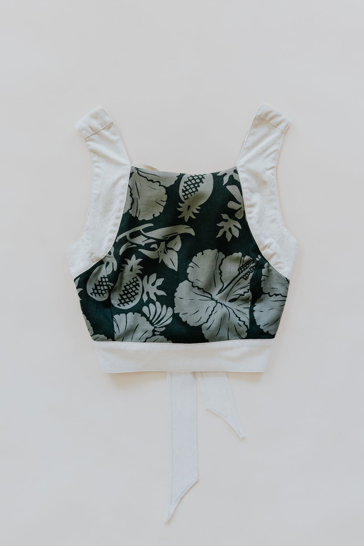 Wings Hawaii pinafore crop top in Hana Forest. Dark green aloha print hand-drawn and designed in Maui. small batch, sustainable, high quality women's apparel handmade with aloha. 