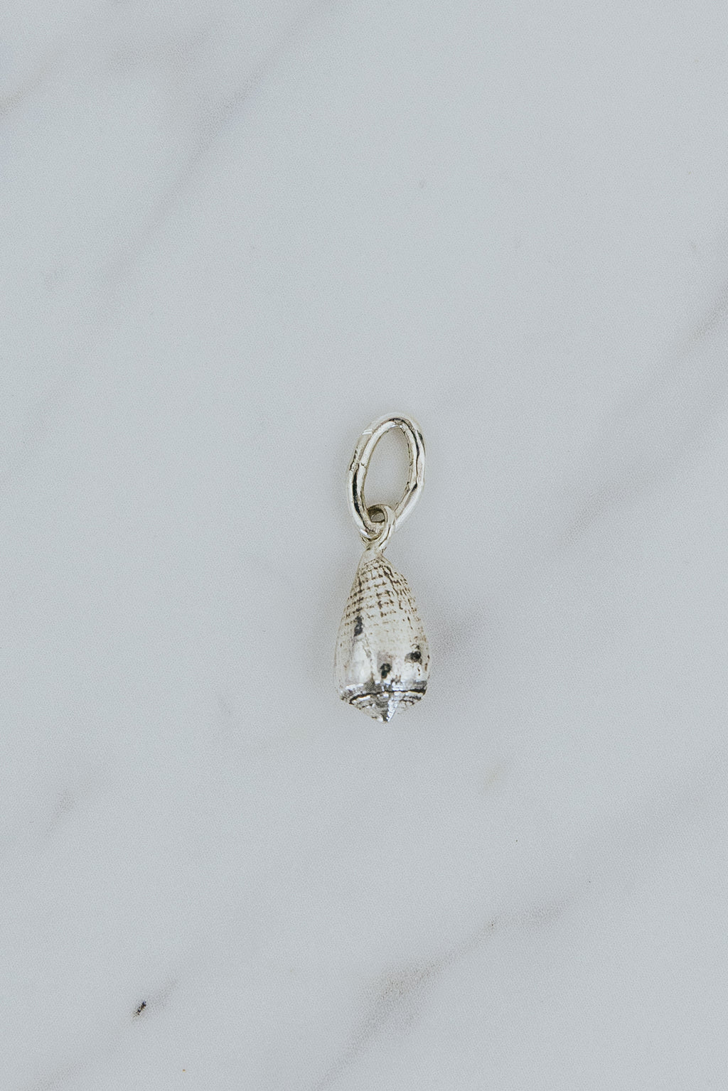 Wings Hawaii Forever Cone Shell necklace charm in sterling silver or solid 14k yellow gold. Fine jewelry handcrafted in Maui. Modern charm necklaces handmade in Hawaii. 