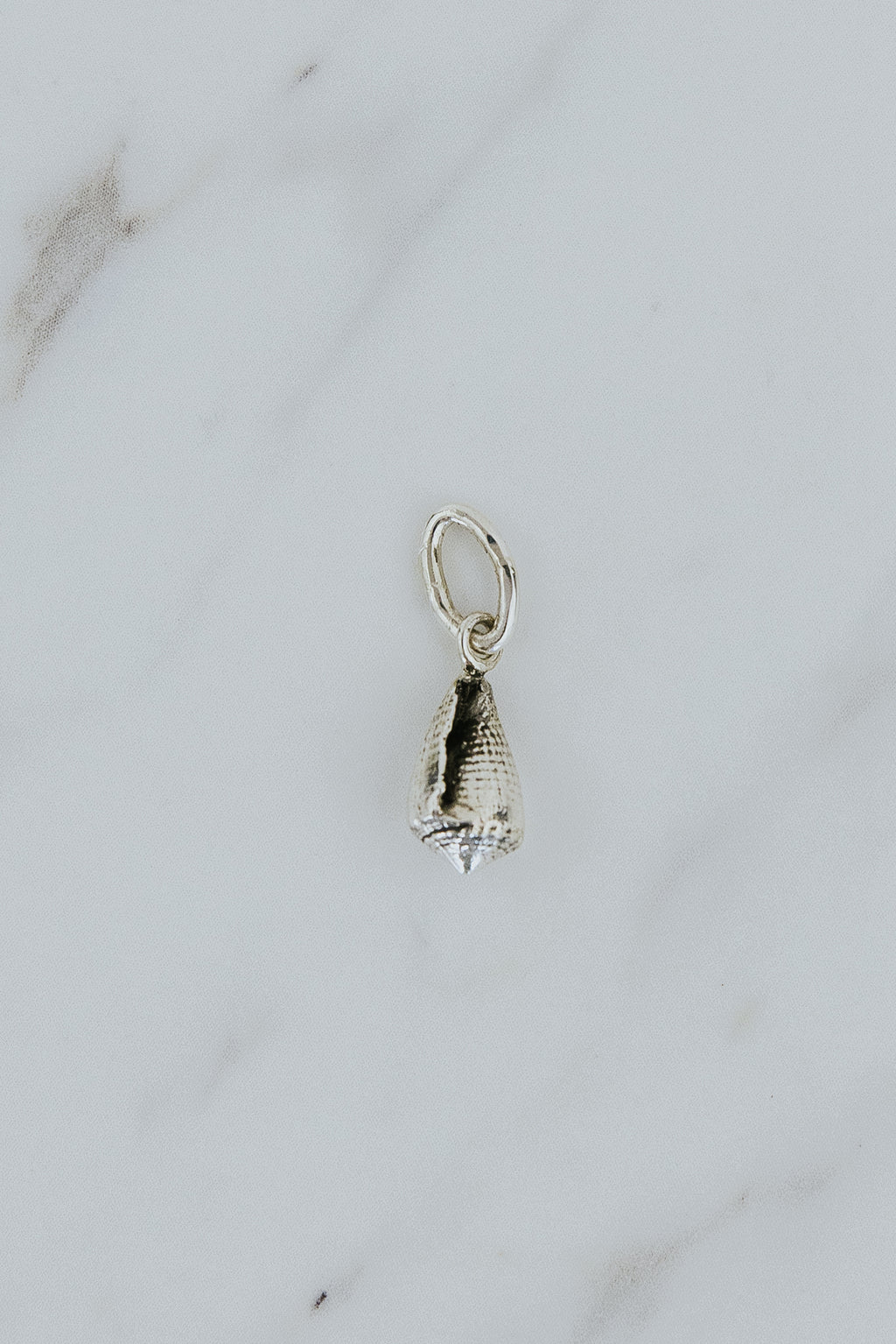 Wings Hawaii Forever Cone Shell necklace charm in sterling silver or solid 14k yellow gold. Fine jewelry handcrafted in Maui. Modern charm necklaces handmade in Hawaii. 