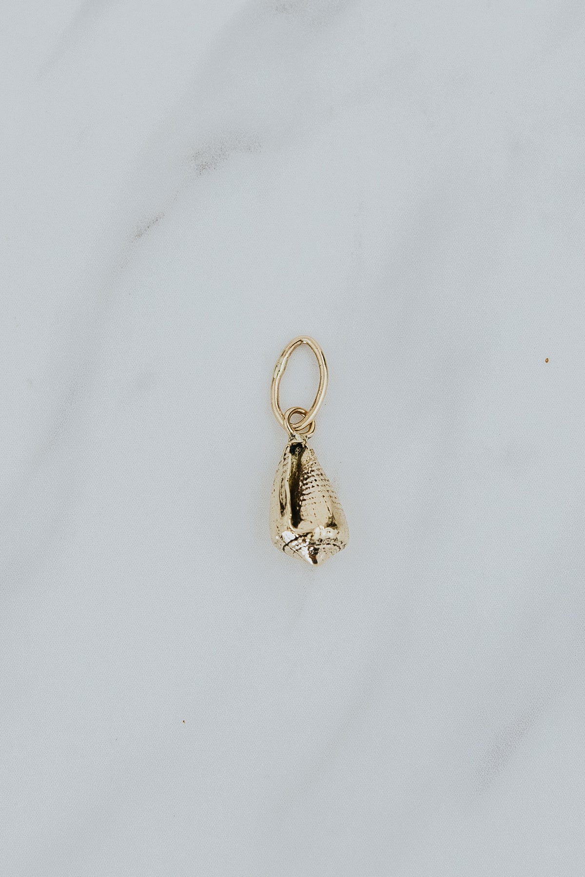 Wings Hawaii Forever Cone Shell necklace charm in sterling silver or solid 14k yellow gold. Fine jewelry handcrafted in Maui. Modern charm necklaces handmade in Hawaii. 