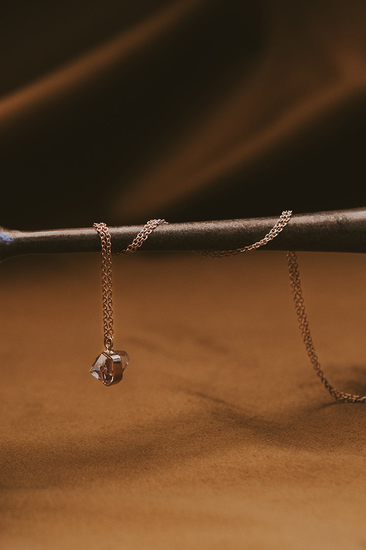 Banded herkimer dangling on a delicate chain necklace