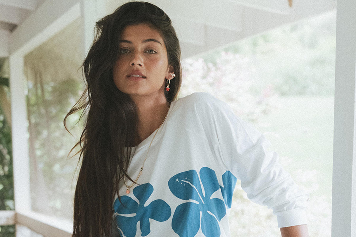 Model in a hibiscus raglan on the porch