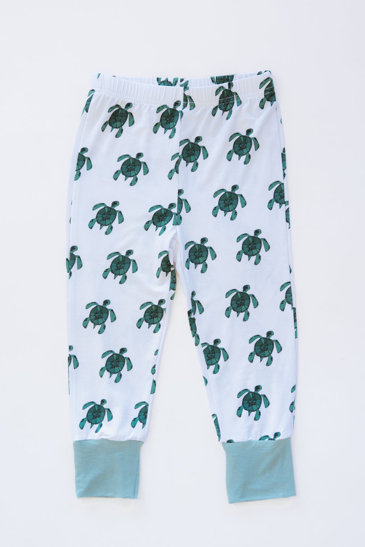 Wings Hawaii Honu kids pajamas set with sea turtles print. Original artwork designed in Maui. Island style keiki gifts. Long sleeved shirt with pajama pants. Small batch, sustainable, unique children’s apparel. 