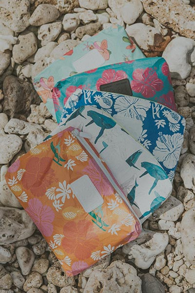 A collection of Wings Hawaii foldable adventure pouches 