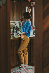 Model wearing Wings Hawaii retro pocket pants in marigold corduroy thumbnail