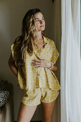 Model wearing Wings Hawaii boxy button-up blouse and retro pocket shorts in quilted ulu and plumeria print in marigold thumbnail