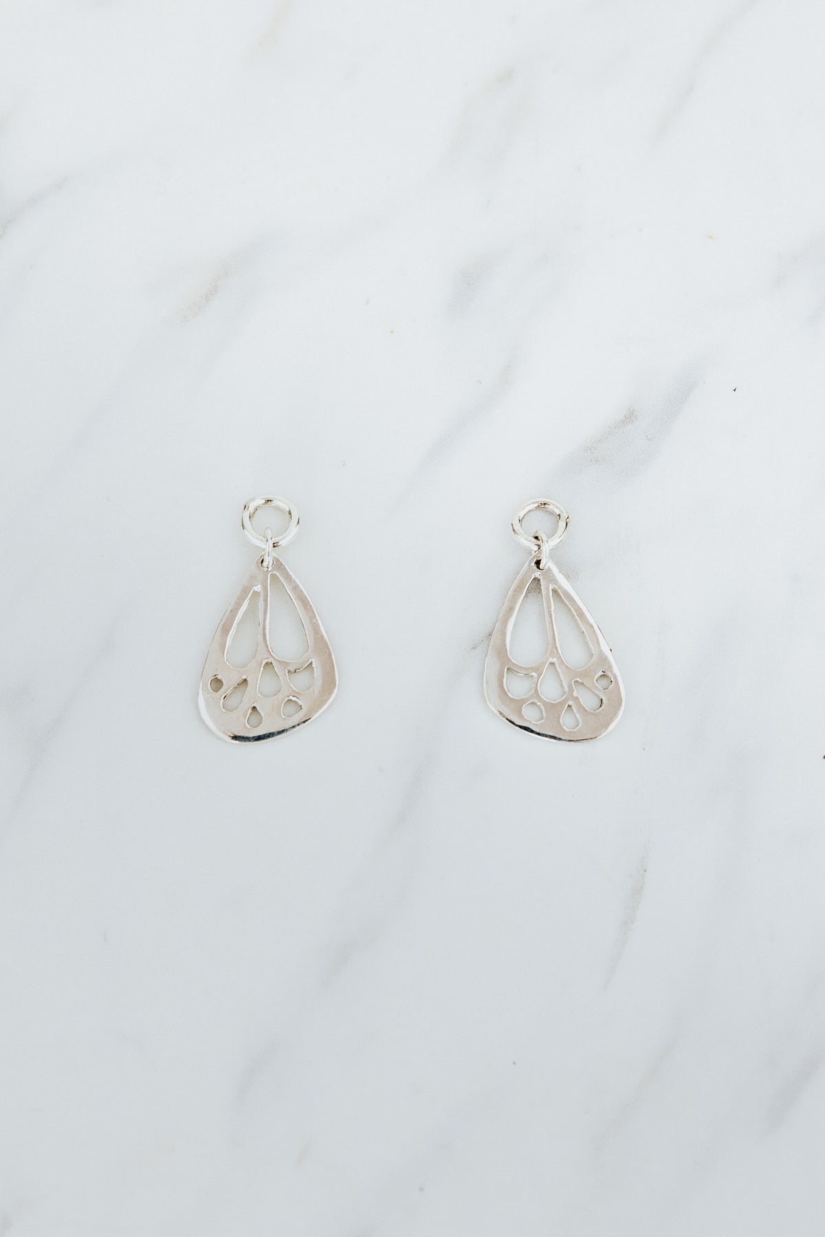 Wings Hawaii signature butterfly Mini Wings earring charms in sterling silver. Charms for hoop earrings. Fine jewelry handmade in Maui. Modern, elevated charm earrings to mix, match, customize. 