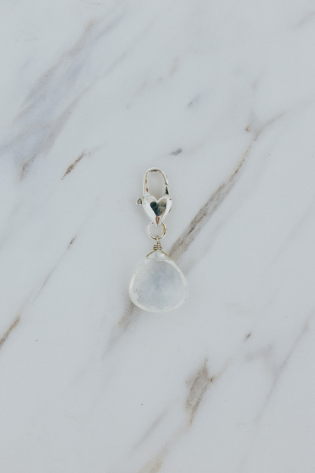 Wings Hawaii Moonstone necklace charm with heart-shaped clasp in sterling silver. Fine jewelry handcrafted in Maui. Charm Bar collection, modern charm necklaces made in Hawaii