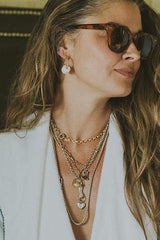 Wings Hawaii model wearing Bombucha Five Puka Endless Hoop Earrings and layered necklaces thumbnail