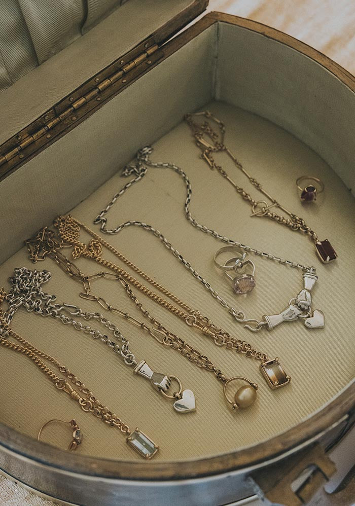 Necklaces in a round wooden tray