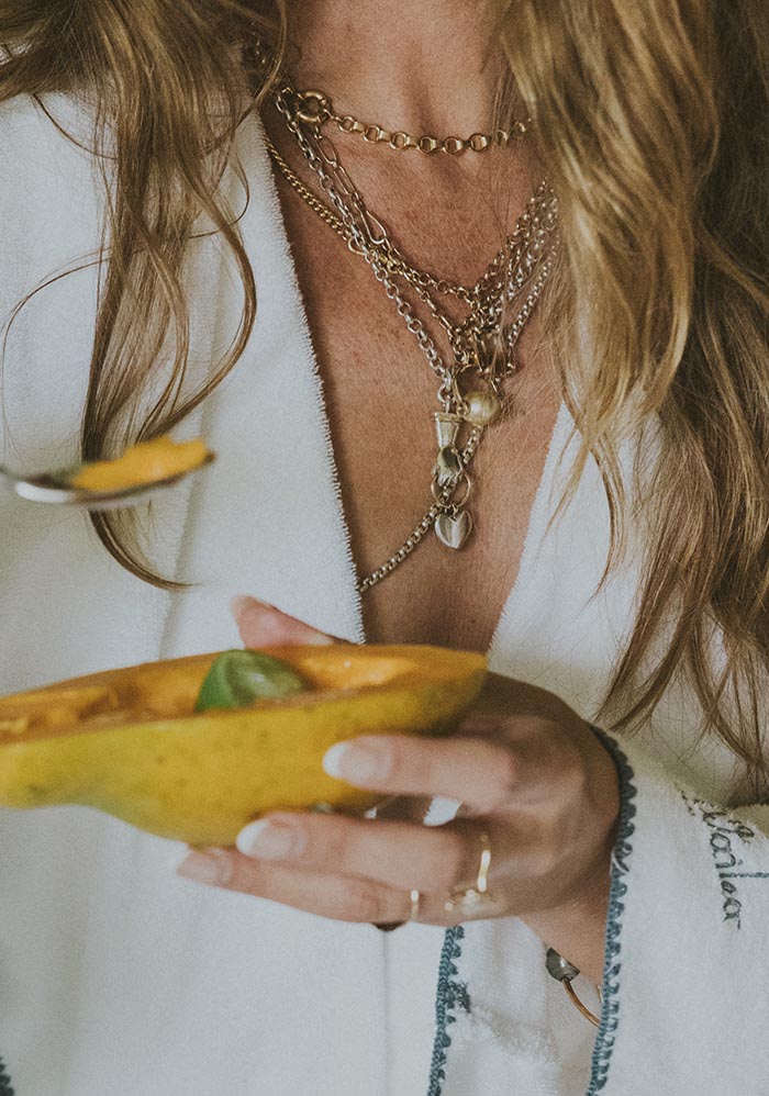 Layered necklaces over a white shirt