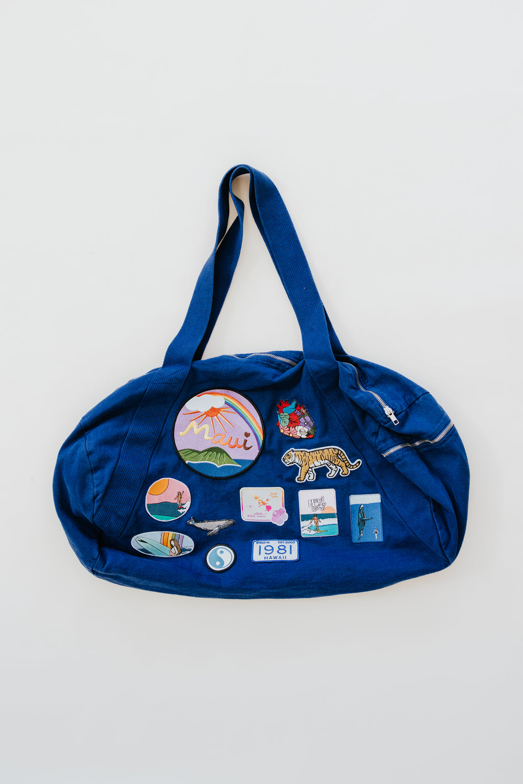 Wings Hawaii patched up cotton duffel bag in blue. Original artwork on embroidered patches - mermaids, surfer girls, whales, tigers, rainbows and more. Handmade with aloha in Maui. 