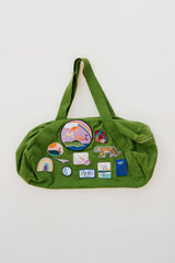 Wings Hawaii patched up cotton duffel bag in green. Original artwork on embroidered patches - mermaids, surfer girls, whales, tigers, rainbows and more. Handmade with aloha in Maui.  thumbnail