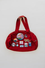 Wings Hawaii patched up cotton duffel bag in red. Original artwork on embroidered patches - mermaids, surfer girls, whales, tigers, rainbows and more. Handmade with aloha in Maui.  thumbnail
