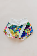 Wings Hawaii Patchwork Pau Hana Shorts in Tropic Rush. Handmade, one of a kind, upcycled vintage quilt fabric. Stretchy cotton waistband and back pocket. Made with aloha in Maui. Sustainable, small batch, slow fashion.  thumbnail