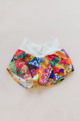 Wings Hawaii Patchwork Pau Hana Shorts in Tropic Rush. Handmade, one of a kind, upcycled vintage quilt fabric. Stretchy cotton waistband and back pocket. Made with aloha in Maui. Sustainable, small batch, slow fashion.  thumbnail