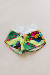 Wings Hawaii Patchwork Pau Hana Shorts in Tropic Rush. Handmade, one of a kind, upcycled vintage quilt fabric. Stretchy cotton waistband and back pocket. Made with aloha in Maui. Sustainable, small batch, slow fashion.  thumbnail