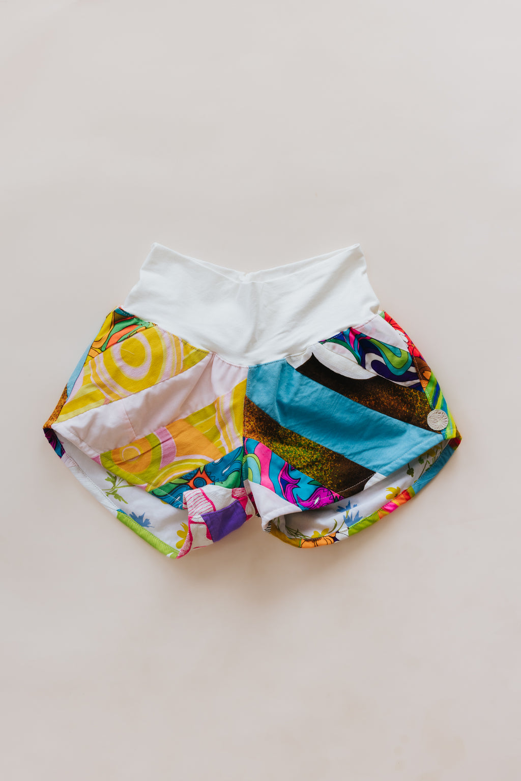 Wings Hawaii Patchwork Pau Hana Shorts in Tropic Rush. Handmade, one of a kind, upcycled vintage quilt fabric. Stretchy cotton waistband and back pocket. Made with aloha in Maui. Sustainable, small batch, slow fashion. 