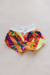 Wings Hawaii Patchwork Pau Hana Shorts in Tropic Rush. Handmade, one of a kind, upcycled vintage quilt fabric. Stretchy cotton waistband and back pocket. Made with aloha in Maui. Sustainable, small batch, slow fashion.  thumbnail