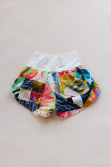 Wings Hawaii Patchwork Pau Hana Shorts in Daisy Lane. Handmade, one of a kind, upcycled vintage quilt fabric. Cozy cotton waistband and back pocket. Made with aloha in Maui. Sustainable, small batch, slow fashion.  thumbnail