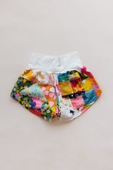 Wings Hawaii Patchwork Pau Hana Shorts in Daisy Lane. Handmade, one of a kind, upcycled vintage quilt fabric. Cozy cotton waistband and back pocket. Made with aloha in Maui. Sustainable, small batch, slow fashion.  thumbnail