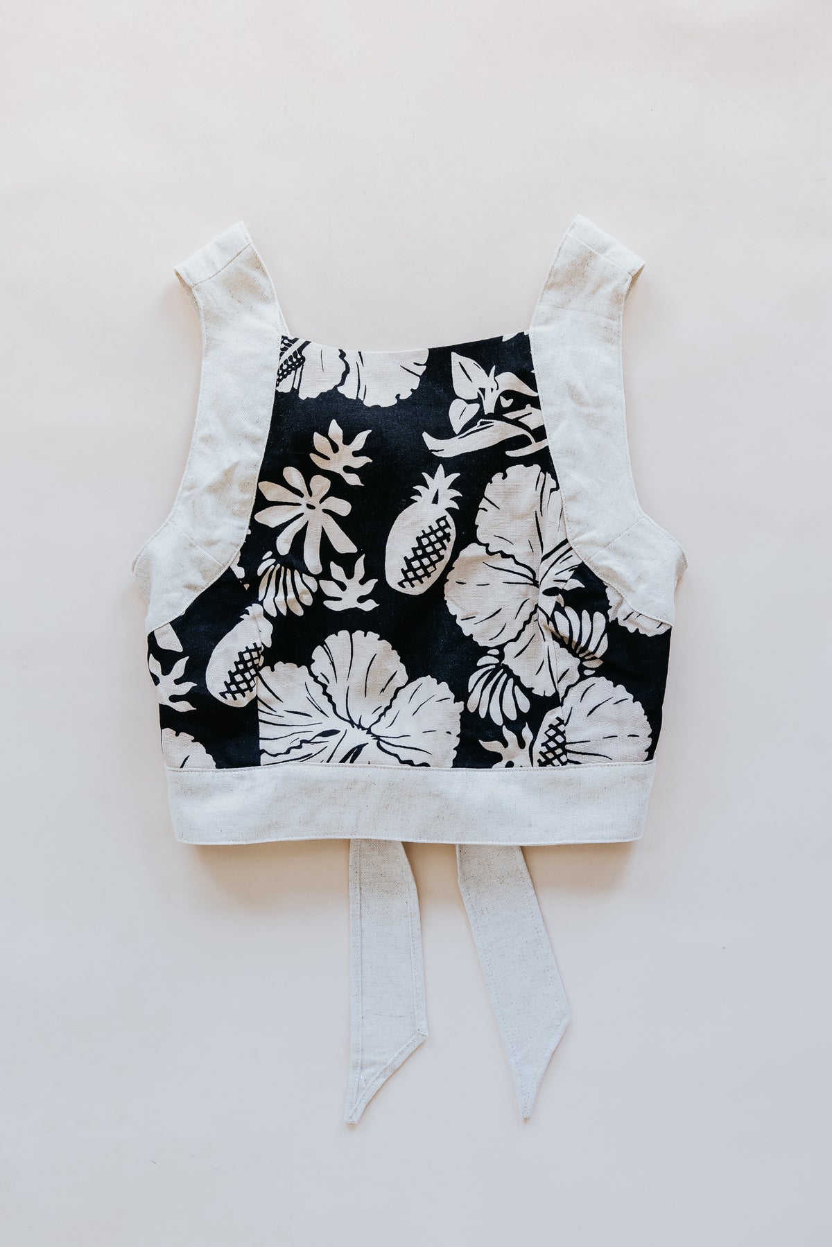 Wings Hawaii pinafore crop top in Hana Nightfall. Black and tan aloha print clothing handmade in Maui. 