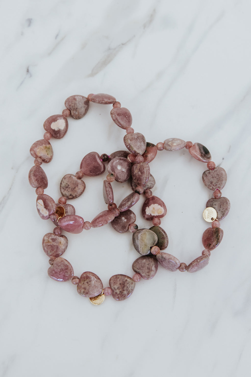 Wings Hawaii Rhodochrosite heart-shaped beads stretchy bracelet with 14k gold-filled tag. Crystal chakra healing. Boho-chic spiritual jewelry handmade in Maui.