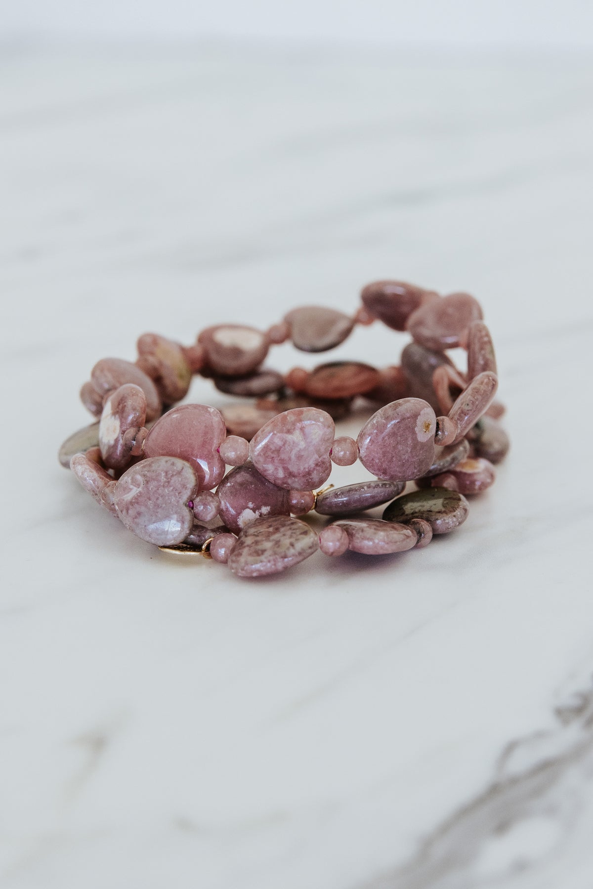 Wings Hawaii Rhodochrosite heart-shaped beads stretchy bracelet with 14k gold-filled tag. Crystal chakra healing. Boho-chic spiritual jewelry handmade in Maui.