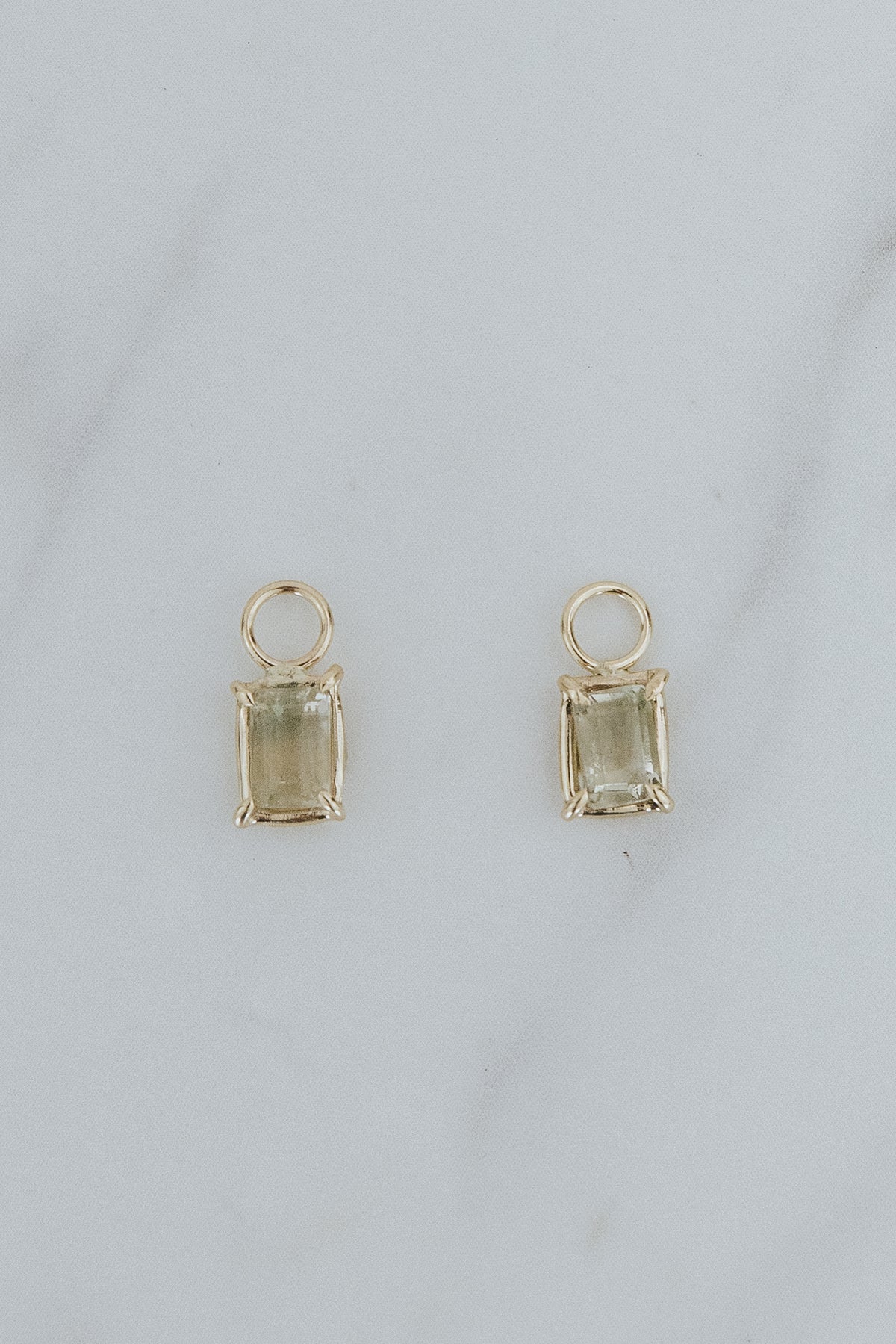 Wings Hawaii earring charms, bi-color Sunstones, clear to light green, in 14k yellow gold. Fine jewelry handmade in Maui. 