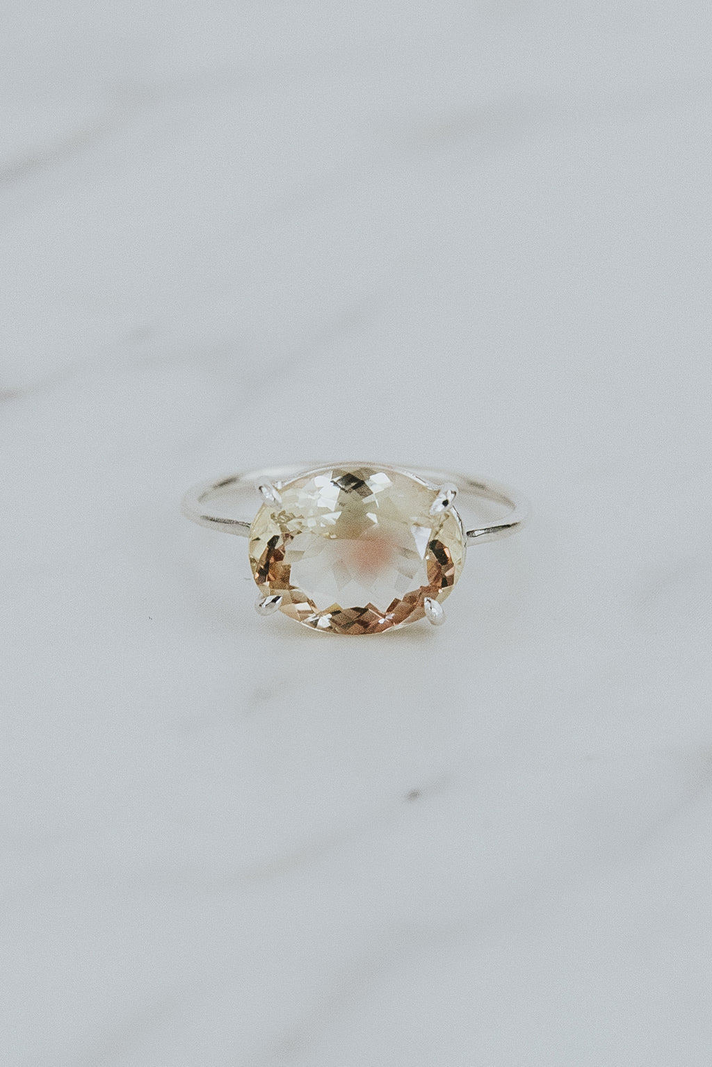 Wings Hawaii Halo ring – Bi-color Sunstone in sterling silver. Fine jewelry handcrafted in Maui. Oval-cut gemstone, single prong-set on delicate band. Made in Hawaii gifts. 