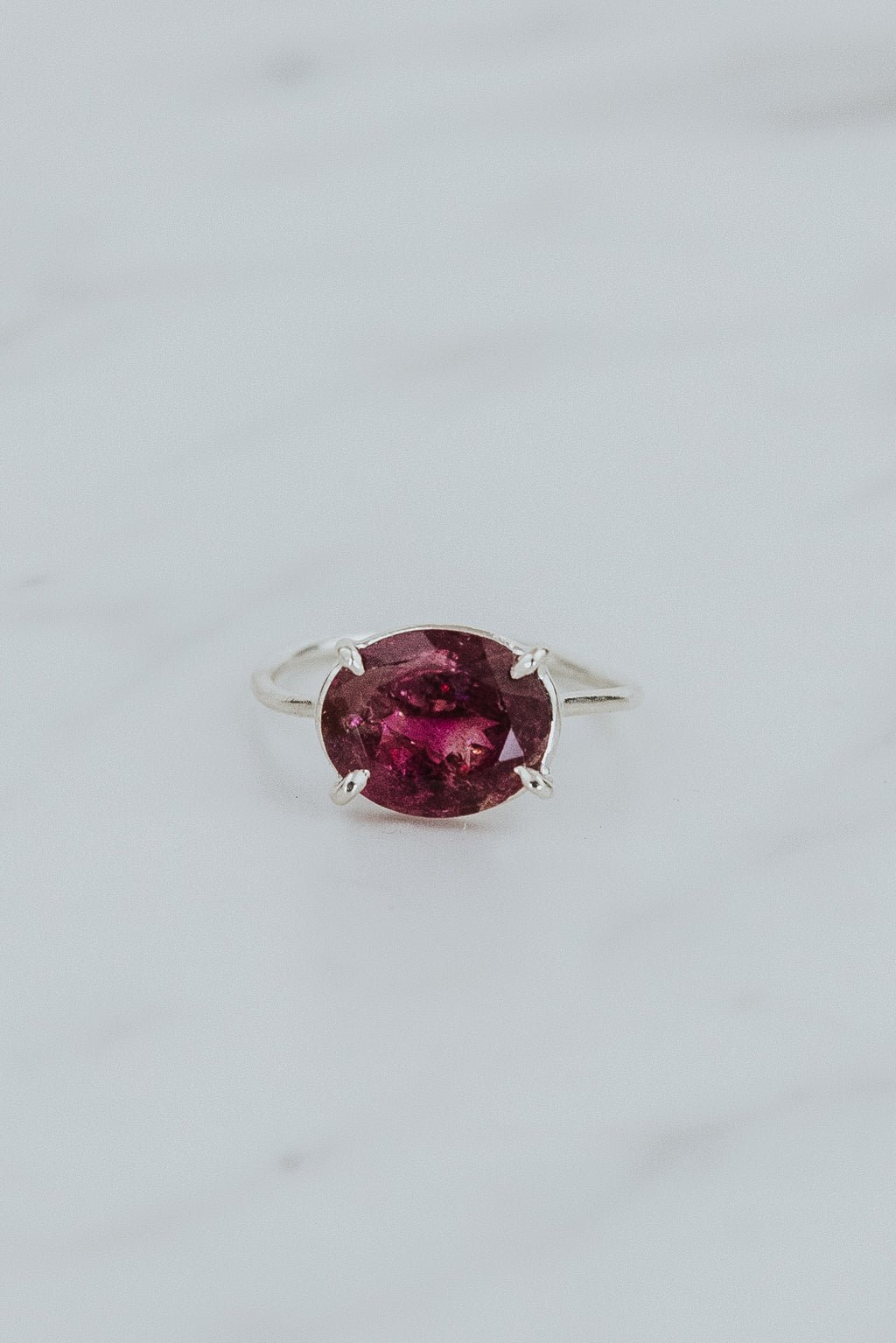 Wings Hawaii Halo ring – Deep Pink Tourmaline in sterling silver. Fine jewelry handcrafted in Maui. Oval-cut gemstone, single prong-set on delicate band. Made in Hawaii gifts. 