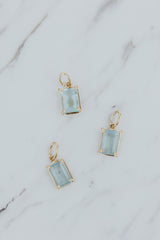 Wings Hawaii Aquamarine necklace charm. Emerald-cut and prong-set in 14k gold-filled. Fine jewelry handcrafted with aloha in Maui. Charm Bar collection. Mix, match, customize modern charm jewelry made in Hawaii. 
