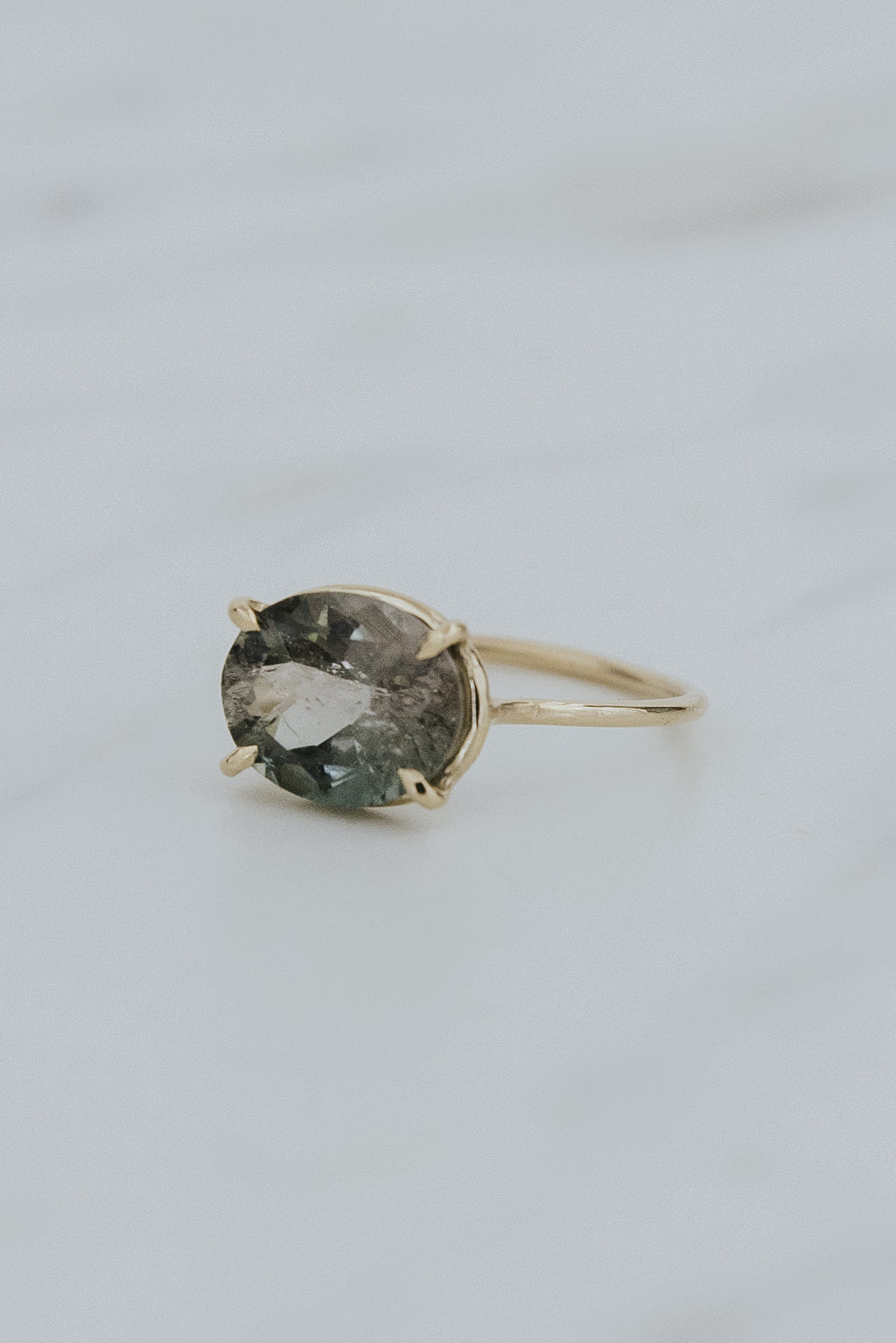 Wings Hawaii Halo ring – Green Tourmaline in solid 14k yellow gold. Fine jewelry handcrafted in Maui. Oval-cut gemstone, single prong-set on delicate band. Made in Hawaii gifts. 