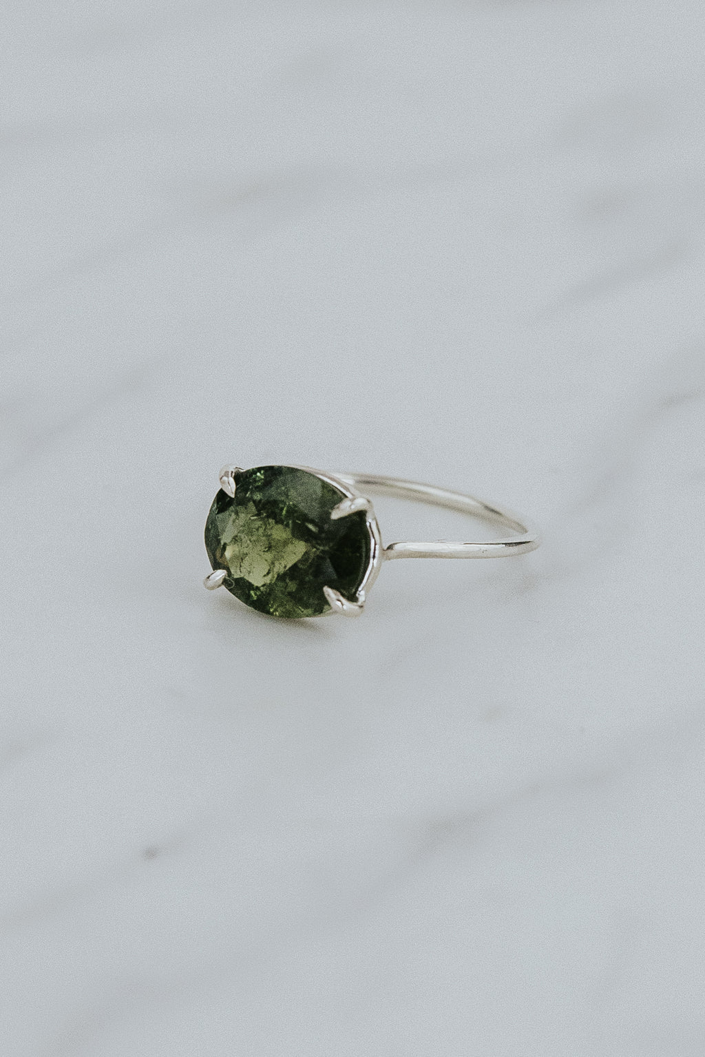 Wings Hawaii Halo ring – Green Tourmaline in sterling silver. Fine jewelry handcrafted in Maui. Oval-cut gemstone, single prong-set on delicate band. Made in Hawaii gifts. 
