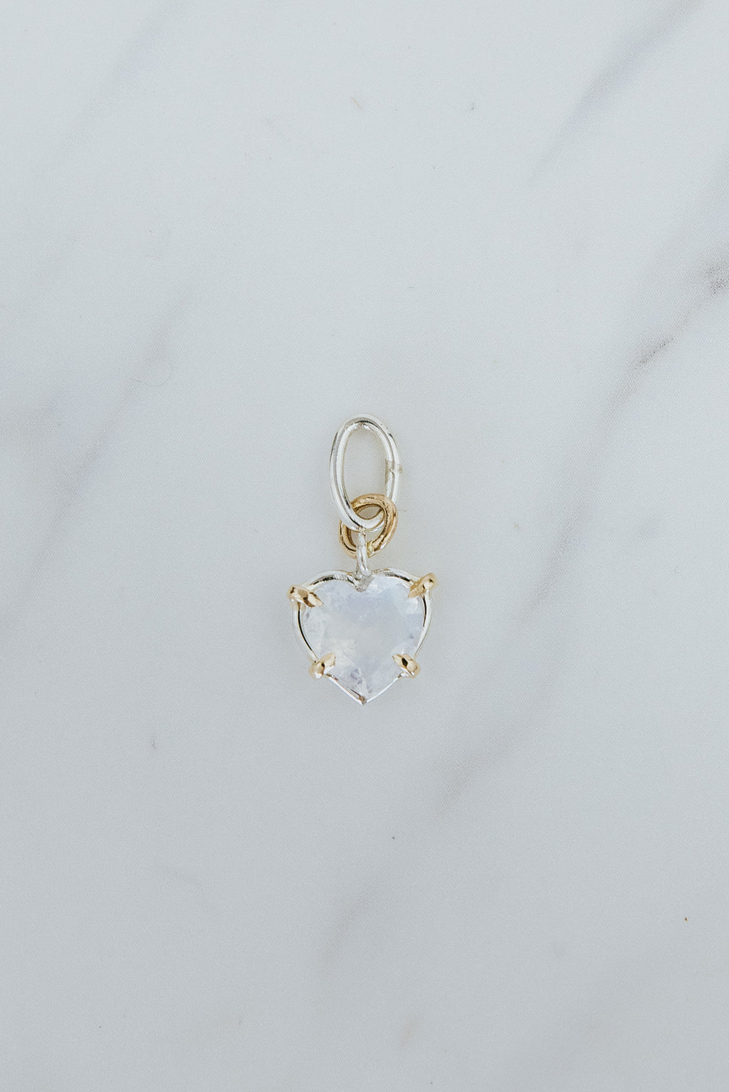 Wings Hawaii heart-shaped rainbow moonstone necklace charm in sterling silver and 14k yellow gold. Fine jewelry handcrafted in Maui. Modern charm necklaces made in Hawaii. 