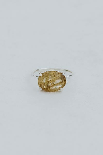 Wings Hawaii Halo ring – Rutilated Quartz in sterling silver. Fine jewelry handcrafted in Maui. Oval-cut gemstone, single prong-set on delicate band. Made in Hawaii gifts.