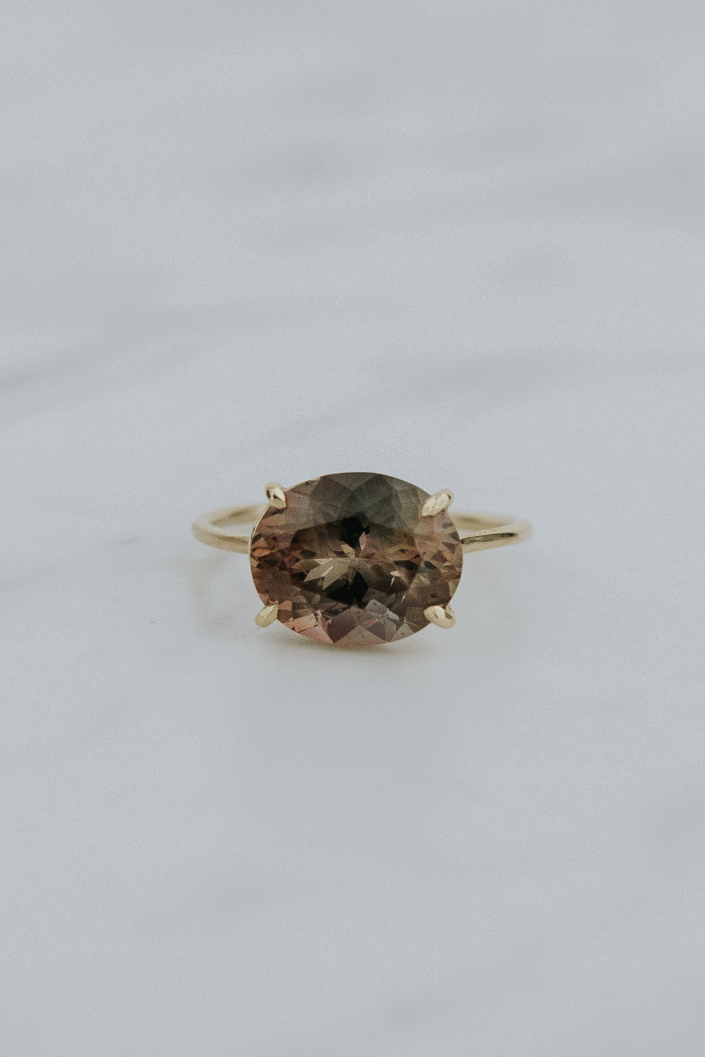 Wings Hawaii Halo ring – Deep Sunstone in solid 14k yellow gold. Fine jewelry handcrafted in Maui. Oval-cut gemstone, single prong-set on delicate band. Made in Hawaii gifts. 