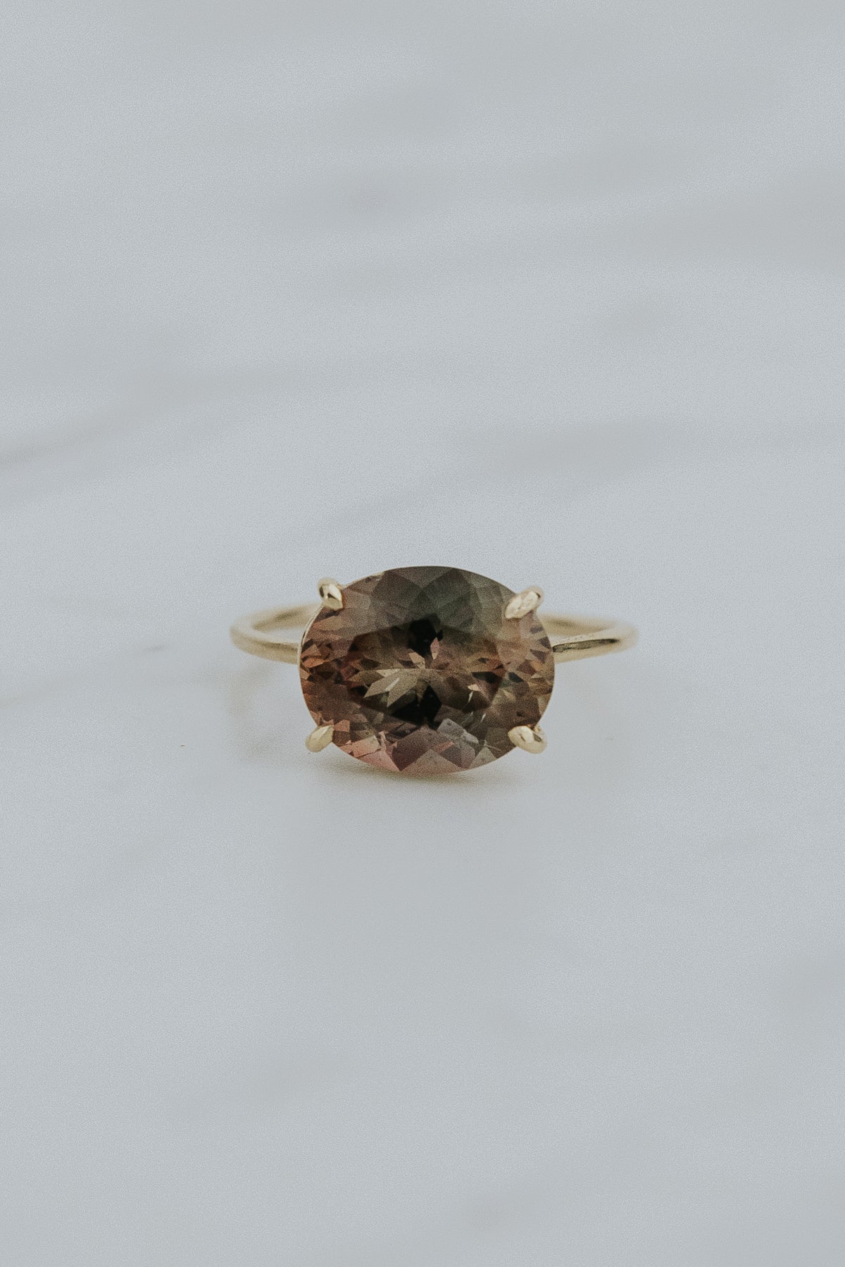 Wings Hawaii Halo ring – Deep Sunstone in solid 14k yellow gold. Fine jewelry handcrafted in Maui. Oval-cut gemstone, single prong-set on delicate band. Made in Hawaii gifts. 