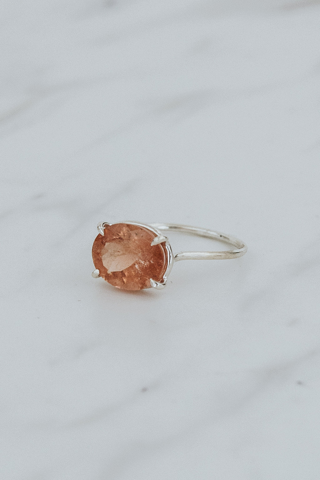 Wings Hawaii Halo ring – Peachy Pink Tourmaline in sterling silver. Fine jewelry handcrafted in Maui. Oval-cut gemstone, single prong-set on delicate band. Made in Hawaii gifts. 