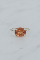 Wings Hawaii Halo ring – Peachy Pink Tourmaline in sterling silver. Fine jewelry handcrafted in Maui. Oval-cut gemstone, single prong-set on delicate band. Made in Hawaii gifts. 
