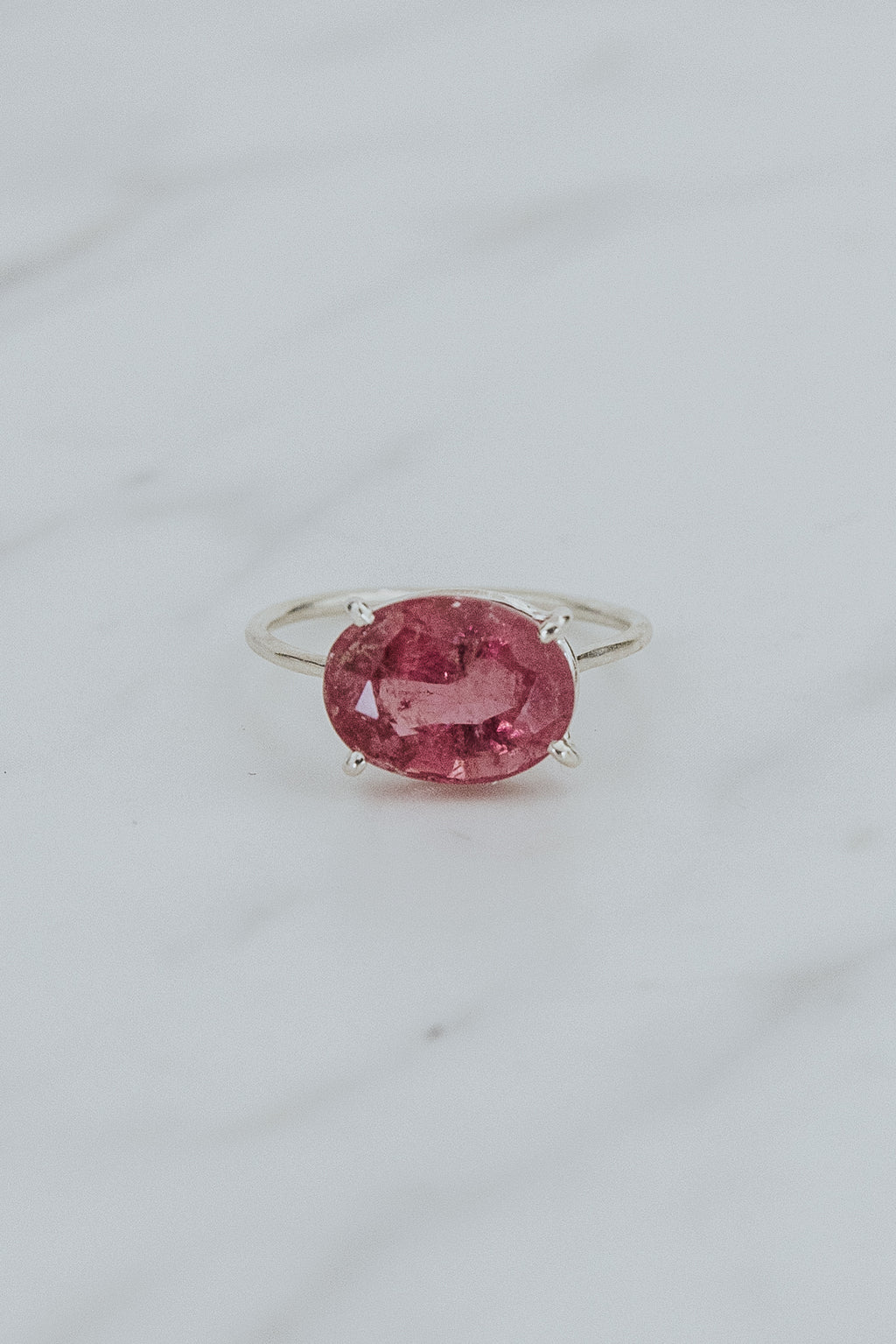 Wings Hawaii Halo ring – Bright Pink Tourmaline in sterling silver. Fine jewelry handcrafted in Maui. Oval-cut gemstone, single prong-set on delicate band. Made in Hawaii gifts. 