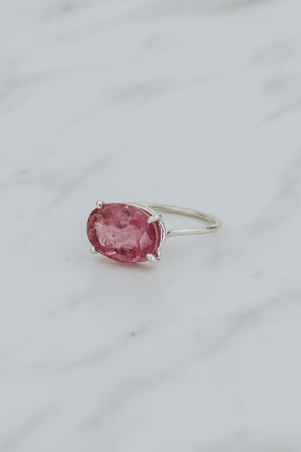 Wings Hawaii Halo ring – Bright Pink Tourmaline in sterling silver. Fine jewelry handcrafted in Maui. Oval-cut gemstone, single prong-set on delicate band. Made in Hawaii gifts. 