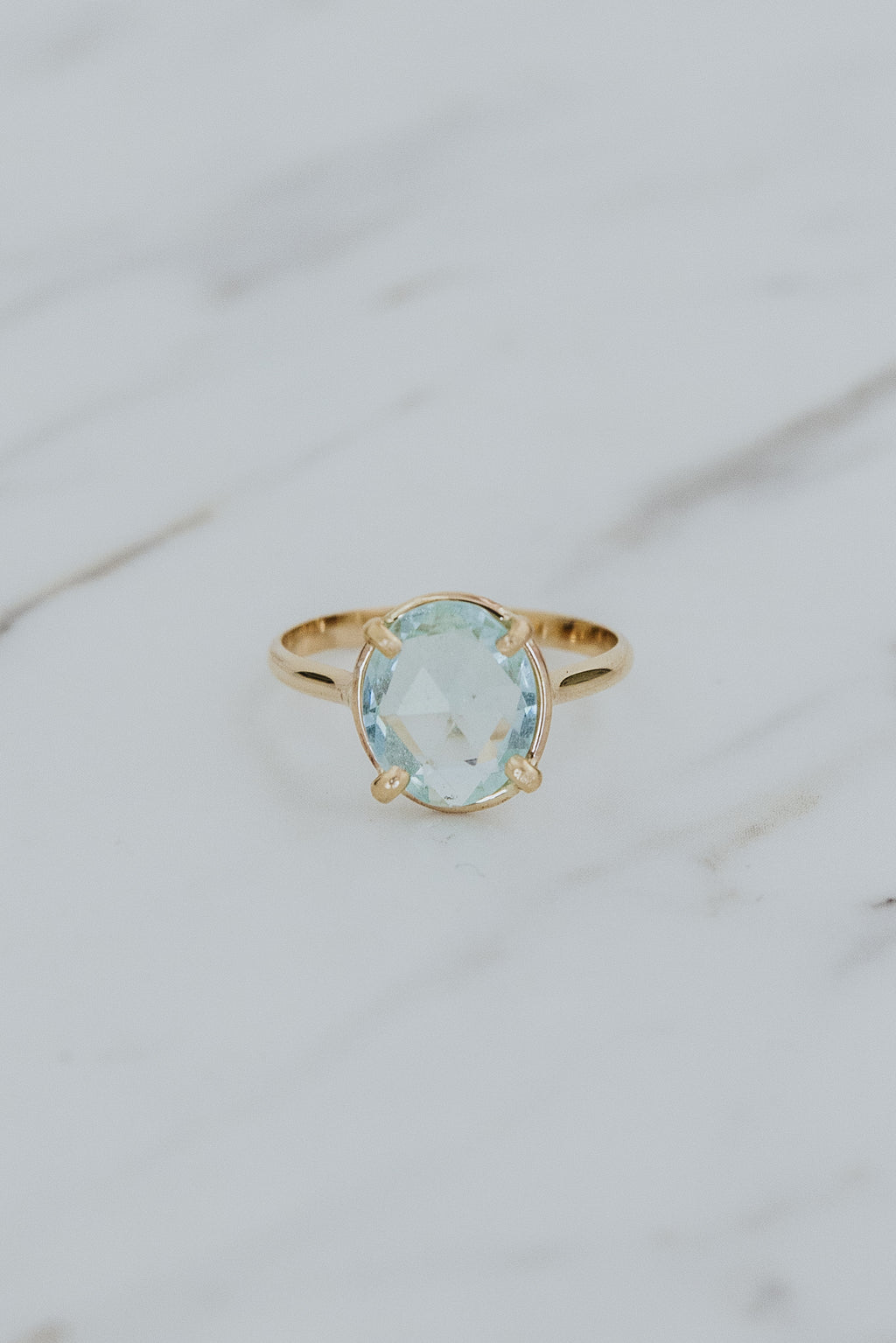 Wings Hawaii rose-cut, prong set Aquamarine Lyra ring in 14k gold-filled. Fine jewelry handcrafted in Maui. Light blue round gemstone in delicate gold ring. High quality jewelry made in Hawaii. 