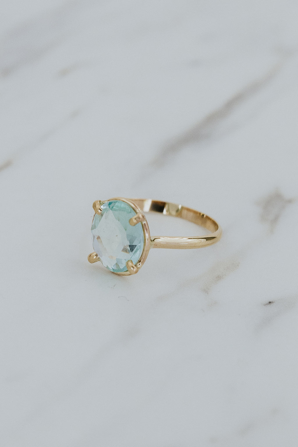 Wings Hawaii rose-cut, prong set Aquamarine Lyra ring in 14k gold-filled. Fine jewelry handcrafted in Maui. Light blue round gemstone in delicate gold ring. High quality jewelry made in Hawaii. 