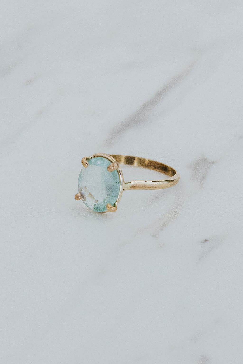 Wings Hawaii rose-cut, prong set Aquamarine Lyra ring in 14k gold-filled. Fine jewelry handcrafted in Maui. Light blue round gemstone in delicate gold ring. High quality jewelry made in Hawaii. 