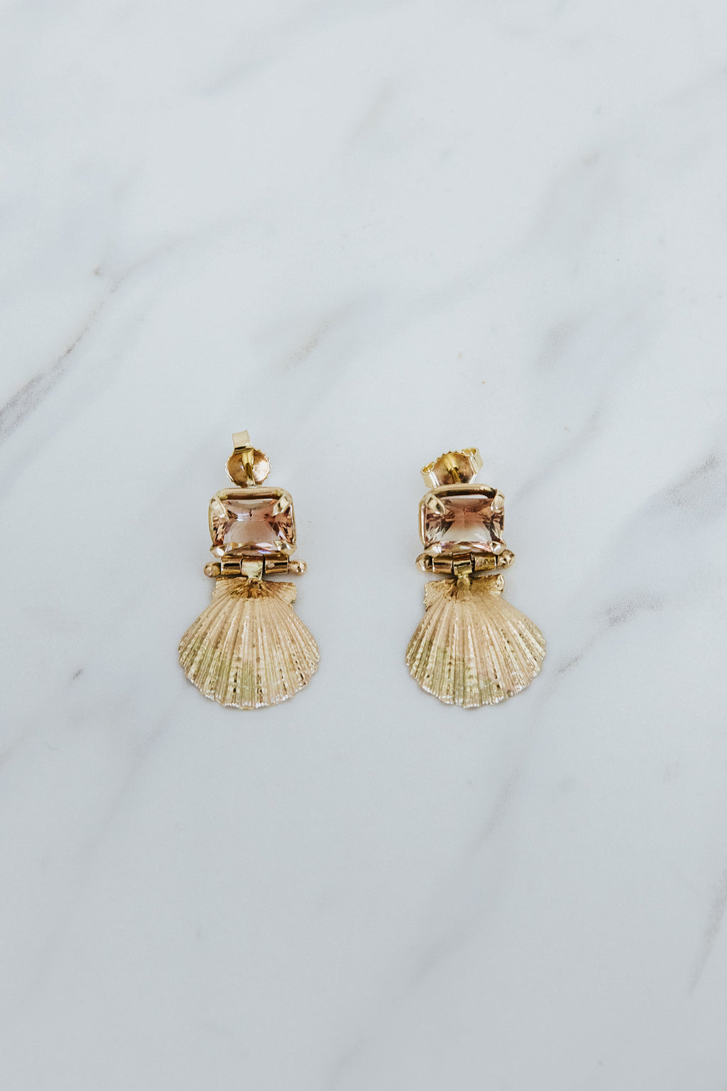 Wings Hawaii Siren Solstice Earrings with Red Schiller Sunstones and Sunrise Shells in solid 14k gold. Hinged for unique movement. Fine jewelry expertly handcrafted in Maui. 