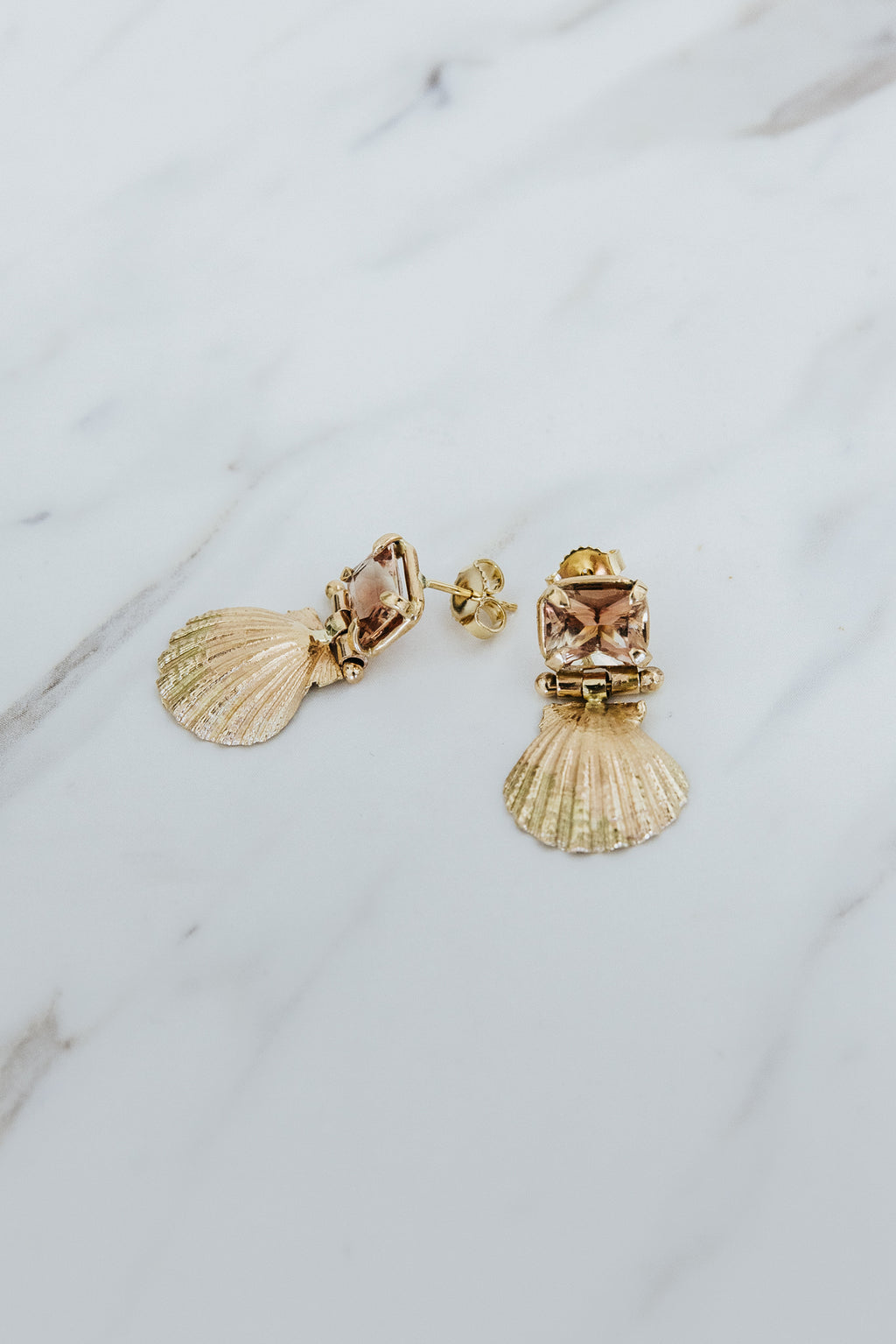 Wings Hawaii Siren Solstice Earrings with Red Schiller Sunstones and Sunrise Shells in solid 14k gold. Hinged for unique movement. Fine jewelry expertly handcrafted in Maui. 