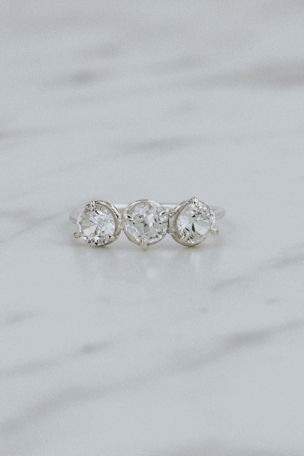 Wings Hawaii Triplet Ring with Clear Zircon gemstones in sterling silver. Fine jewelry handcrafted in Maui. Number three symbolic jewelry gift. 